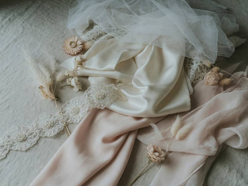 Featured image for Wedding Dress Fabrics, and What Each One Quietly Does Through the Day