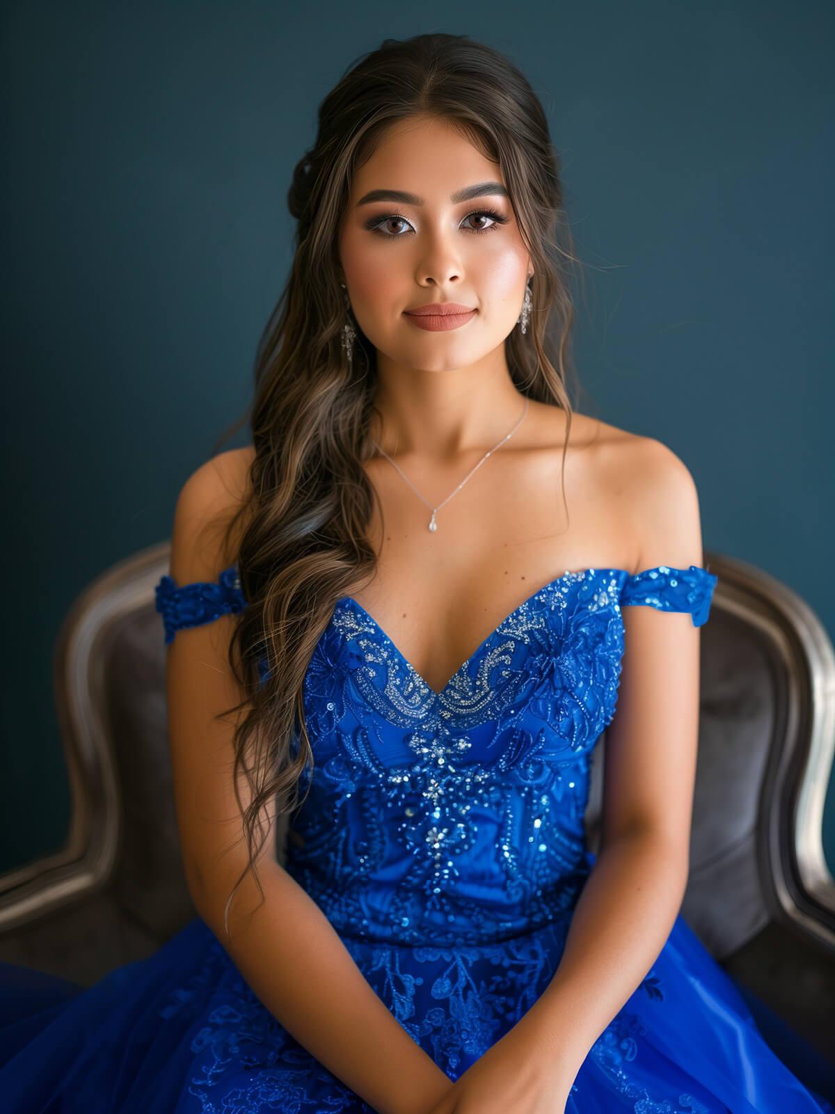A beautiful young woman with long wavy hair wearing an elegant blue off-the-shoulder ballgown with intricate beading.