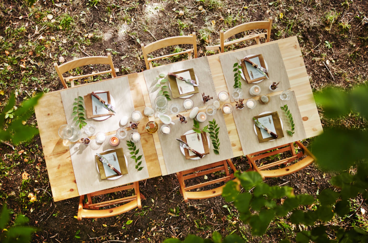 a dinner table in the forest decorated for a wedding