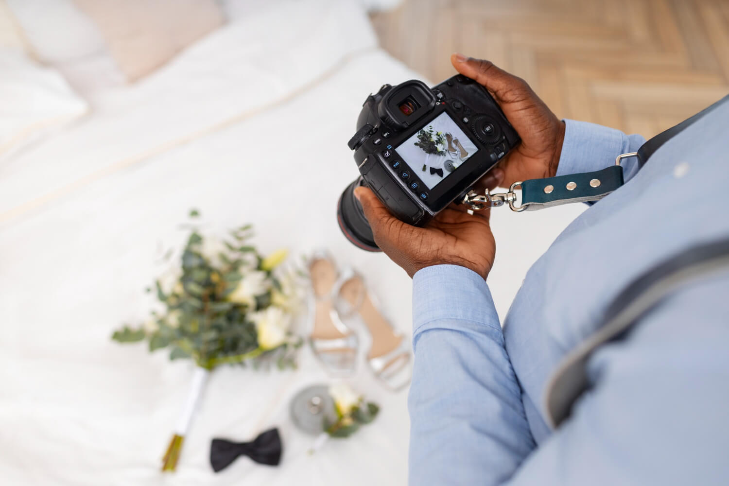 photographer is taking a photo of wedding accessoires including bouquet and the bride shoes