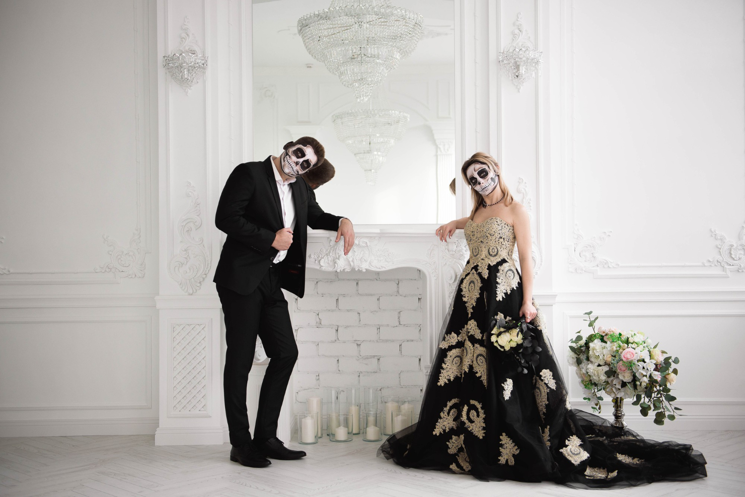 a couple dressed in a macabre outfit with a skull mask makeup