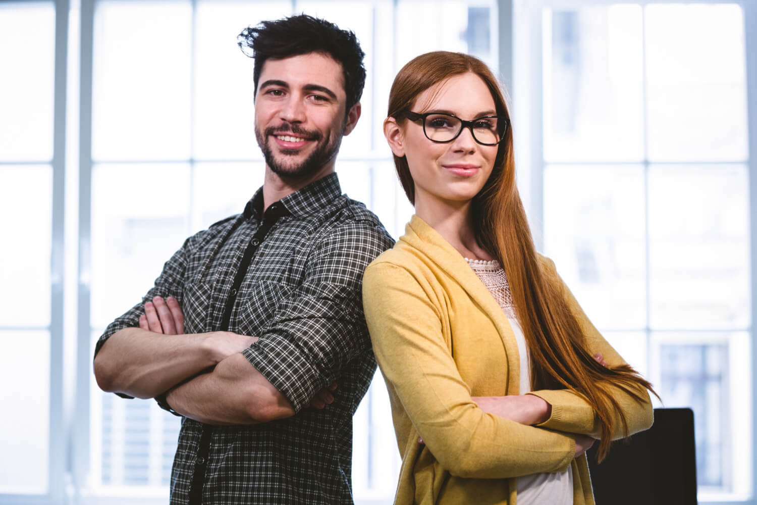 man and woman standing together back to back