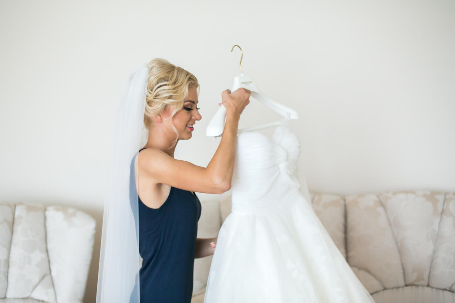 the bride is taking her dress to get ready