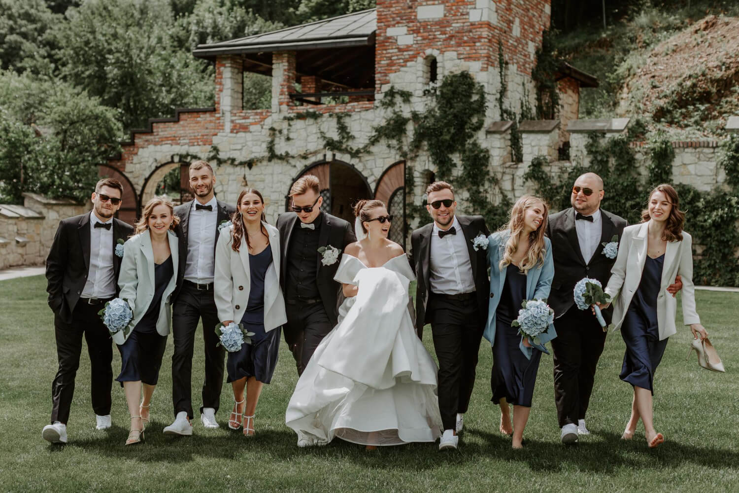 the bride and groom are posing together with a group of friends for a photo on their wedding day