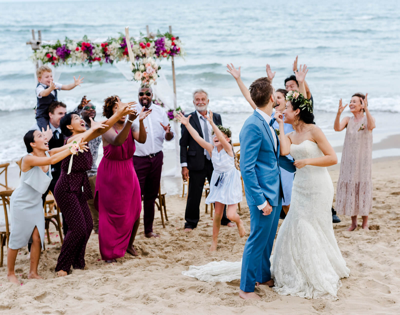 wedding ceremony with bride groom and guests on the beach