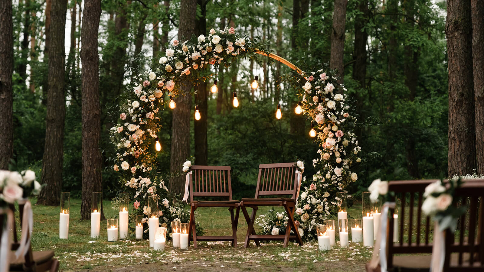 small wedding ceremony with two chairs in the forest