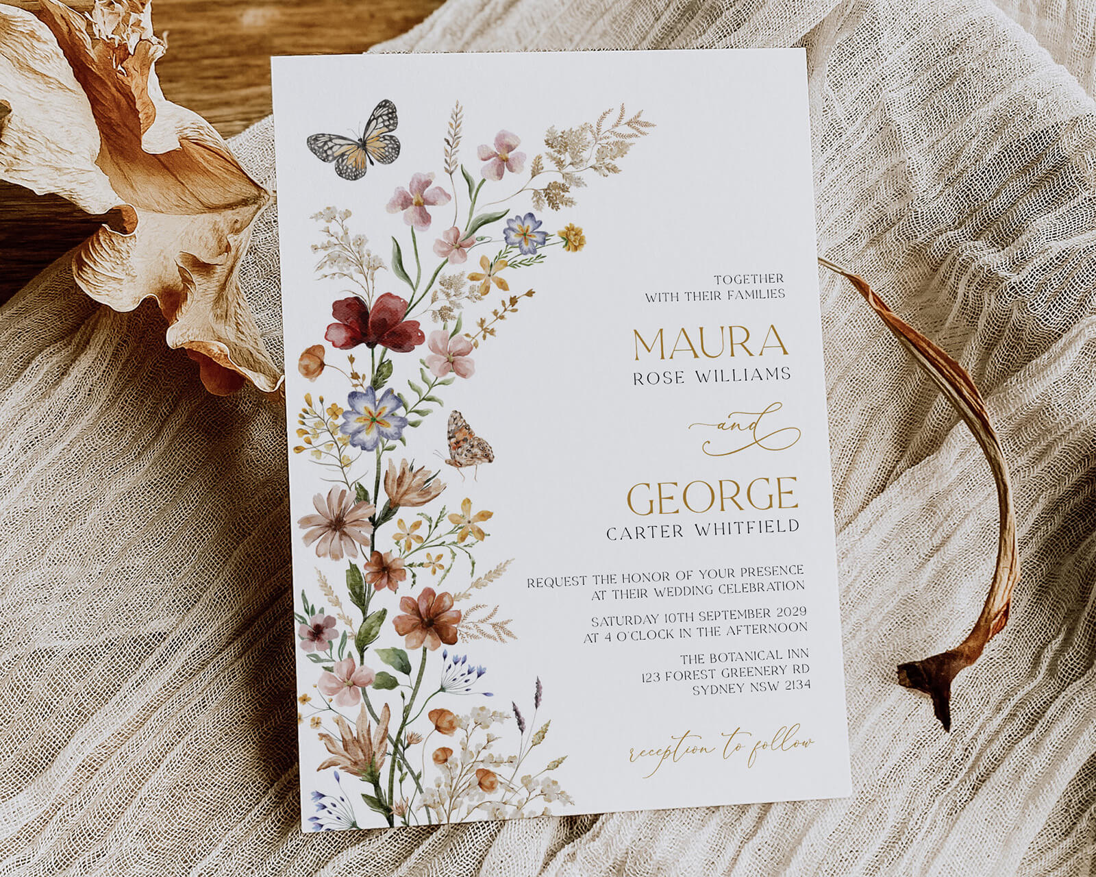 a wedding invitation card with a wildflower design